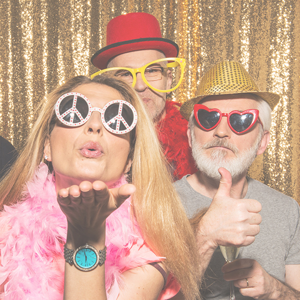 A group of people having fun in a photo booth